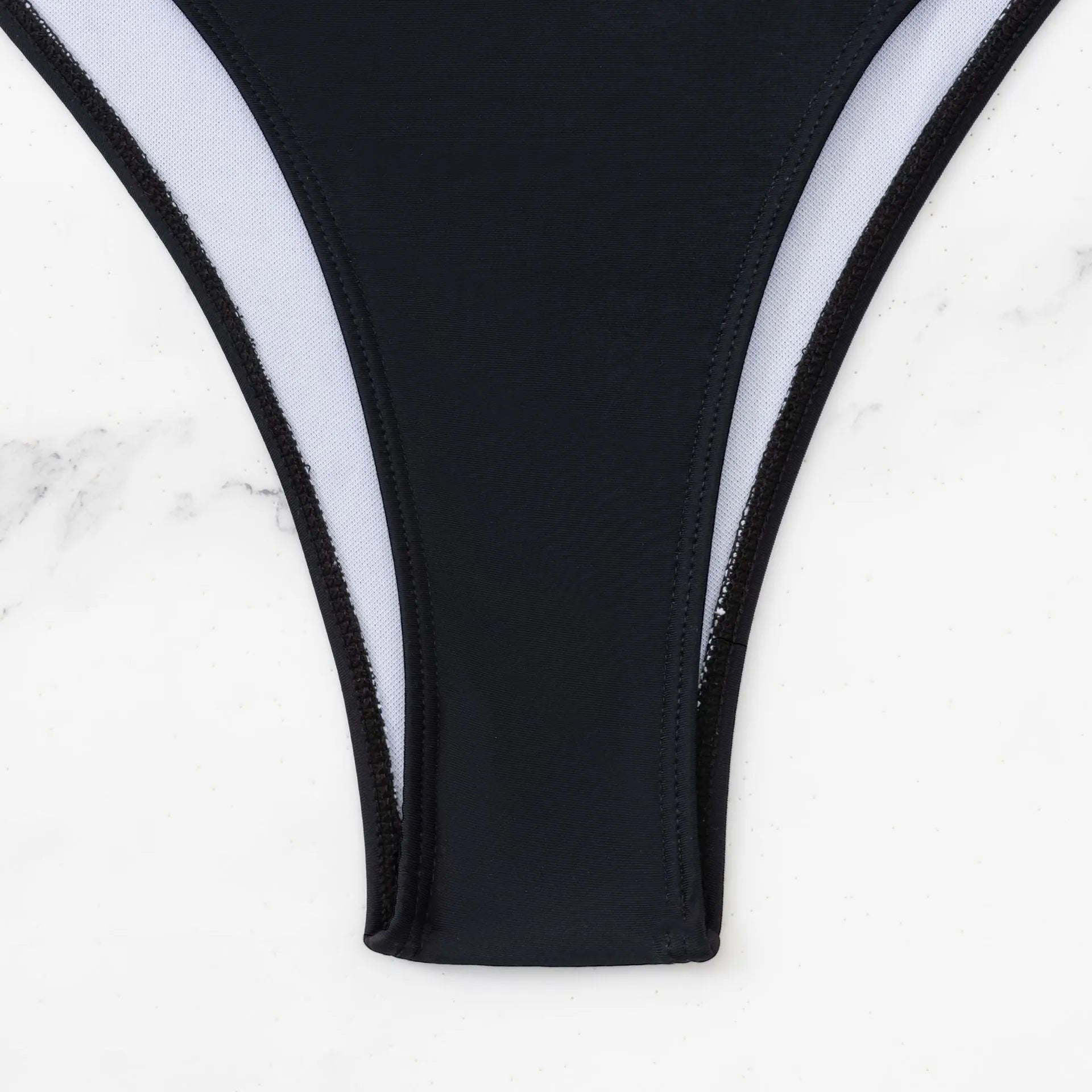 Black women's one-piece swimsuit with white contrast stitching and hollowed sleeveless design