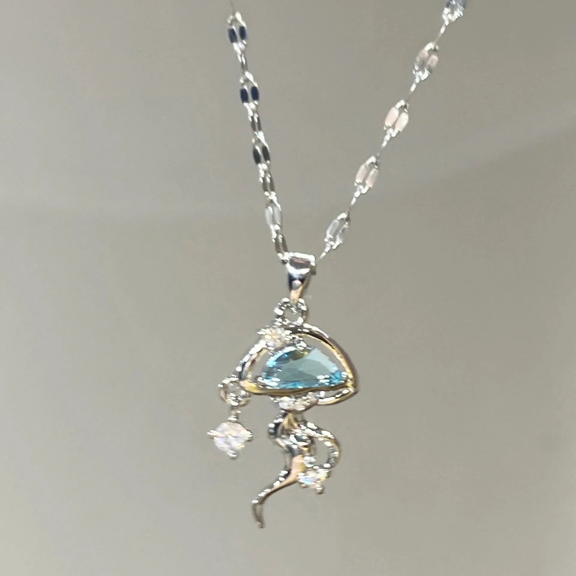 Blue jellyfish pendant necklace on adjustable sterling silver chain with white gold plating
