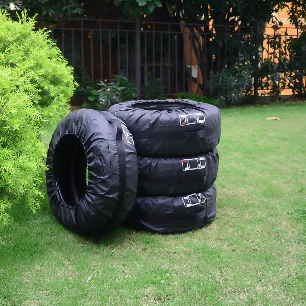 Set of four black polyester car tyre protective covers with a red belt style detail.