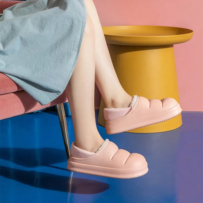A pair of waterproof EVA garden slippers with a plush lining, shown in a solid colour with a non-slip sole.