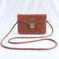 Retro soft surface crossbody messenger bag with flap closure in wine red colour showing internal phone pocket