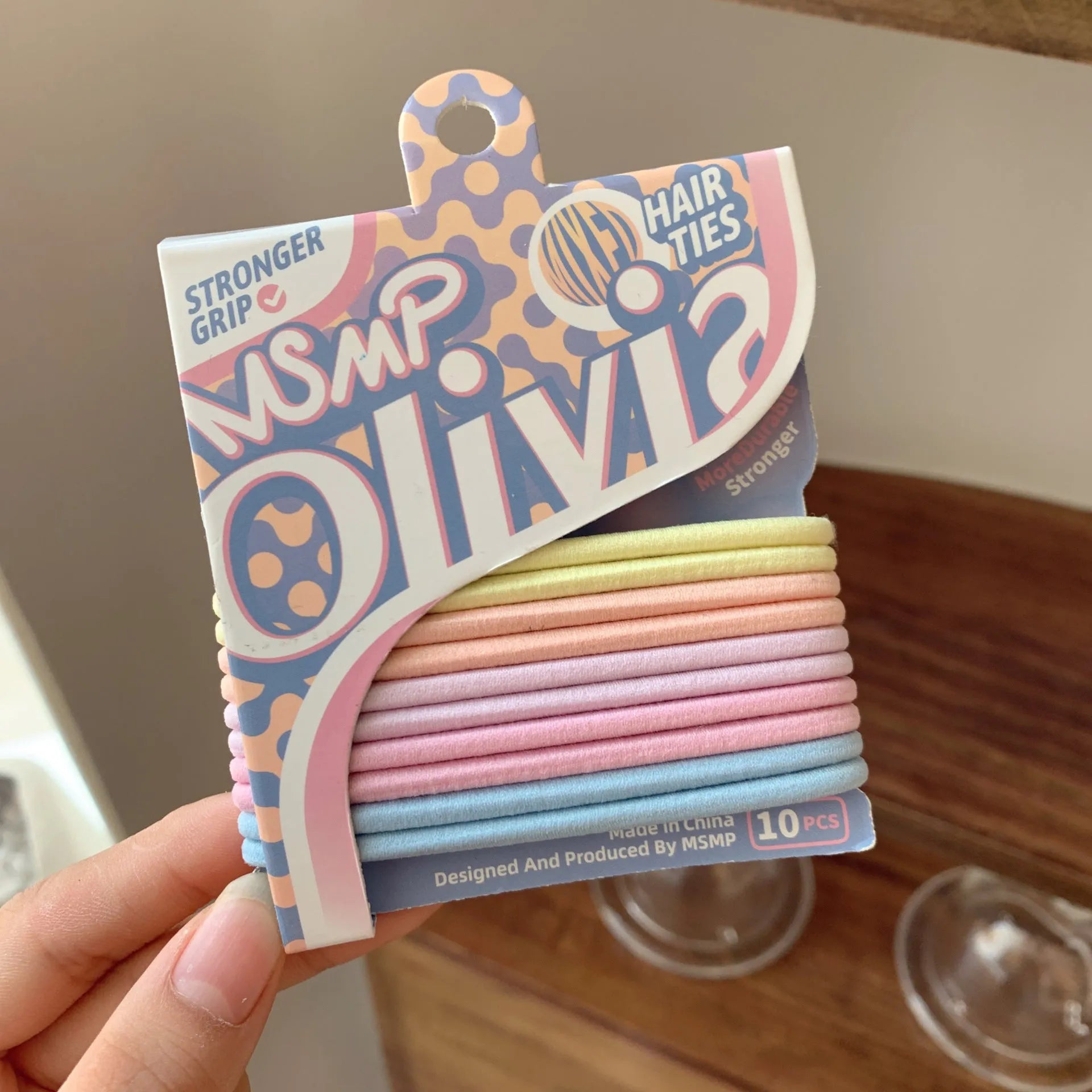 Assorted candy colour braided elastic hair bands laid flat, showing no metal parts.
