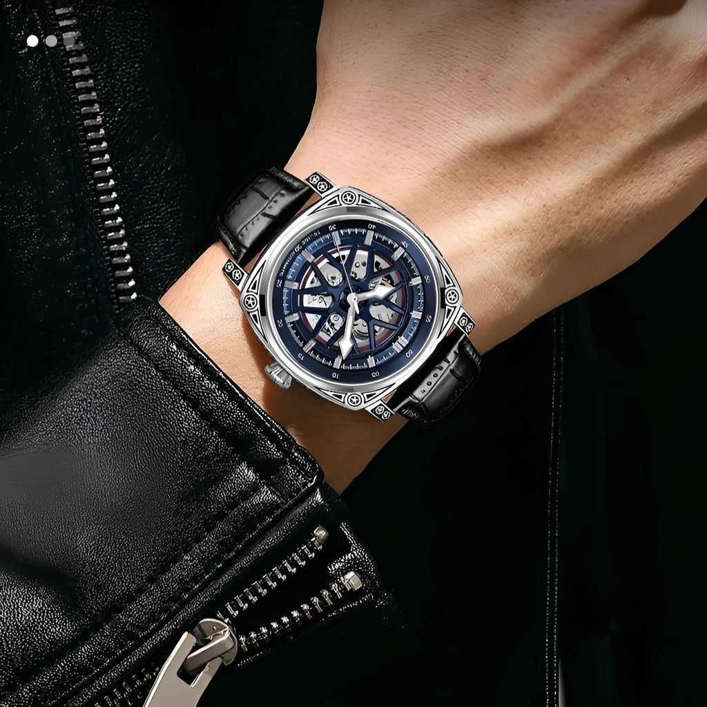 Men's stainless steel automatic watch with a blue leather strap on a wrist.