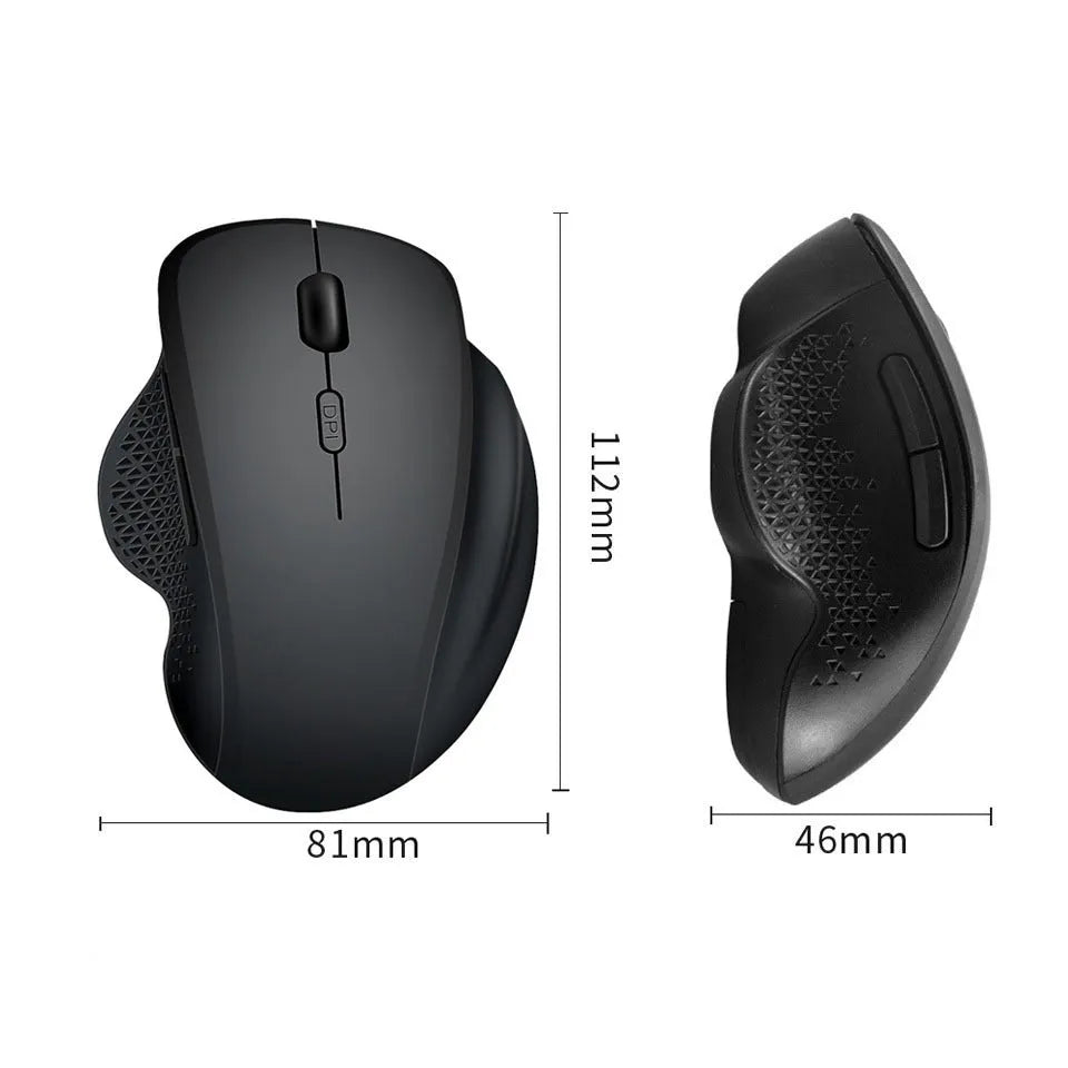 Grey wireless optical mouse with USB charging cable next to laptop computer