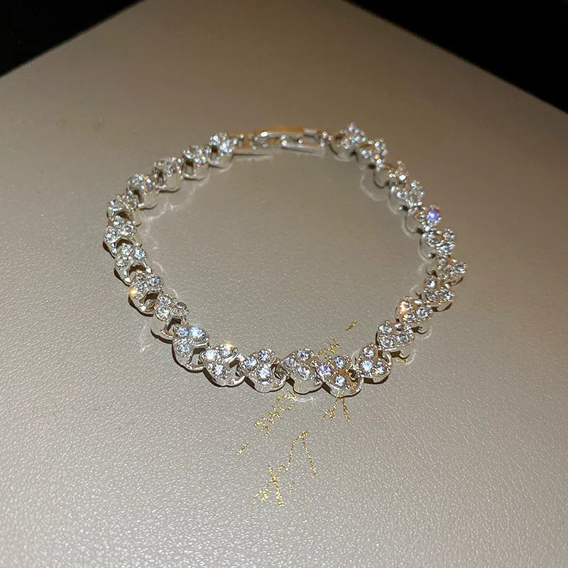 Silver heart shaped metal bracelet with inlaid zircon stones for women