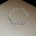 Silver heart shaped metal bracelet with inlaid zircon stones for women