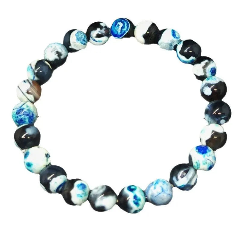 Close-up of a handmade Bohemian bracelet with round 8mm agate-style glass beads on a wrist.