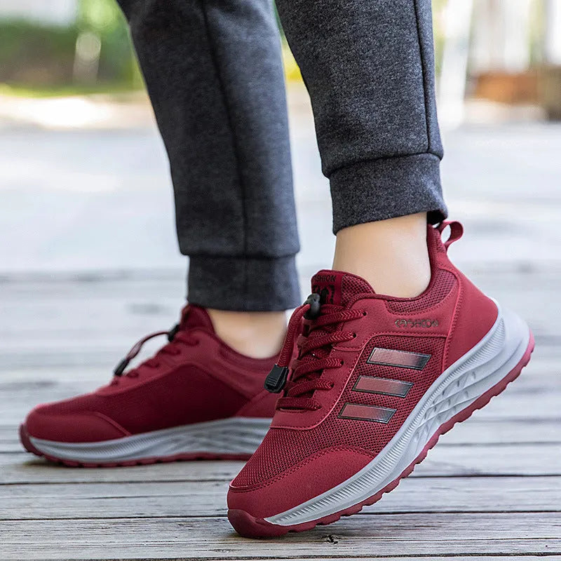 Unisex elastic band slip-on trainer with breathable mesh upper in black, dark grey, purple or purplish red.