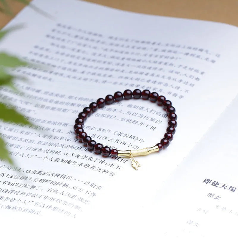 Natural garnet stone set in a 6mm bamboo joint ring bracelet with copper or silver finish.
