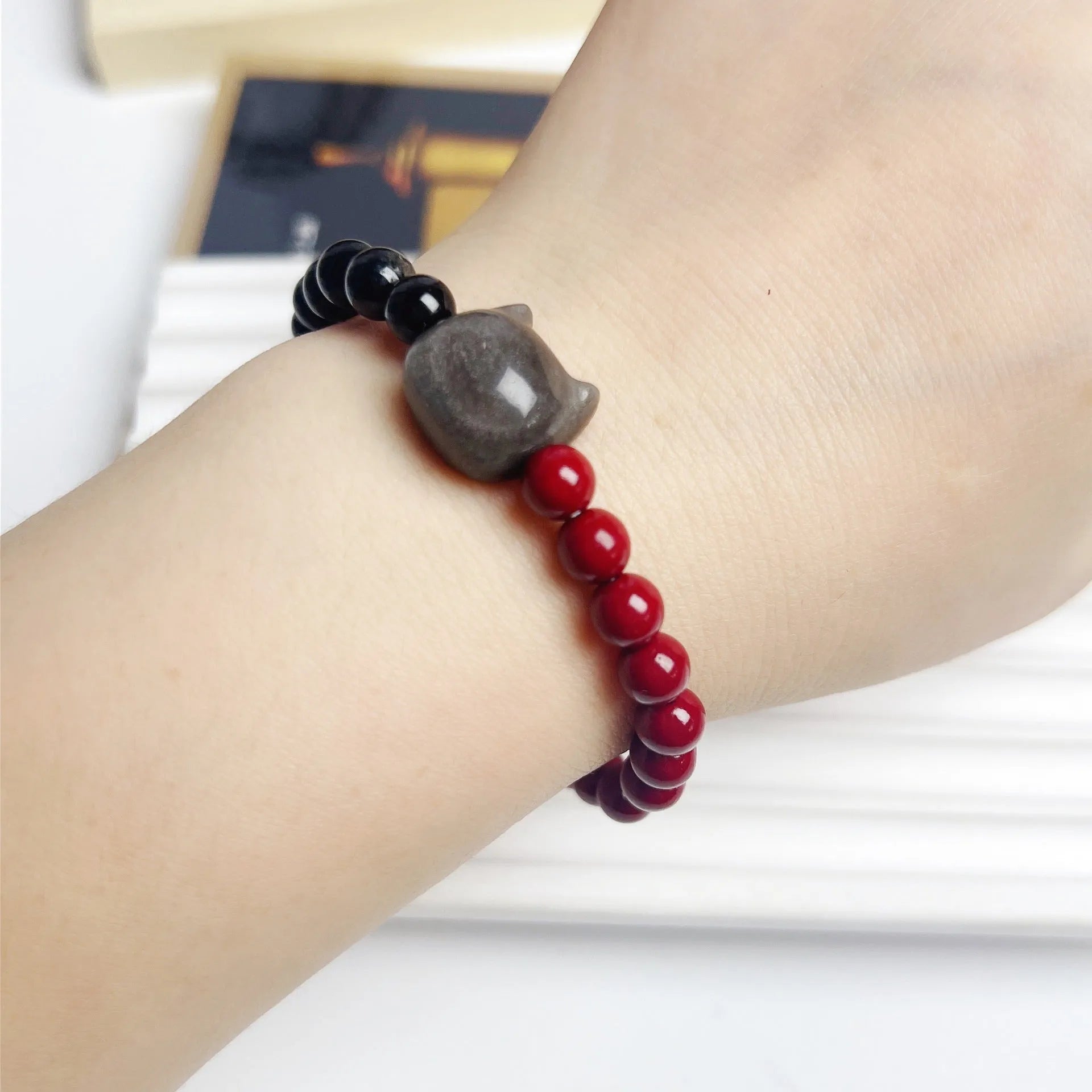 Handmade obsidian gemstone bracelet with cat charm on black elastic cord