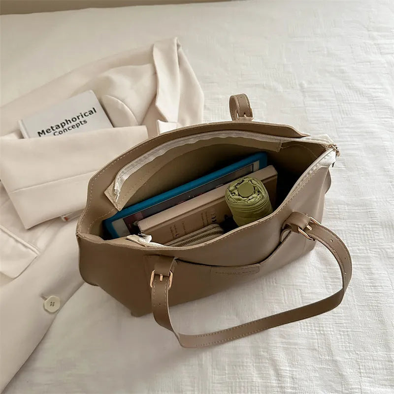 Horizontal square PU tote bag for women in black, showing external sandwich pocket and double shoulder straps.