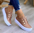 Women's white lace-up flats sneakers with decorative rivet detailing on round toe artificial PU upper