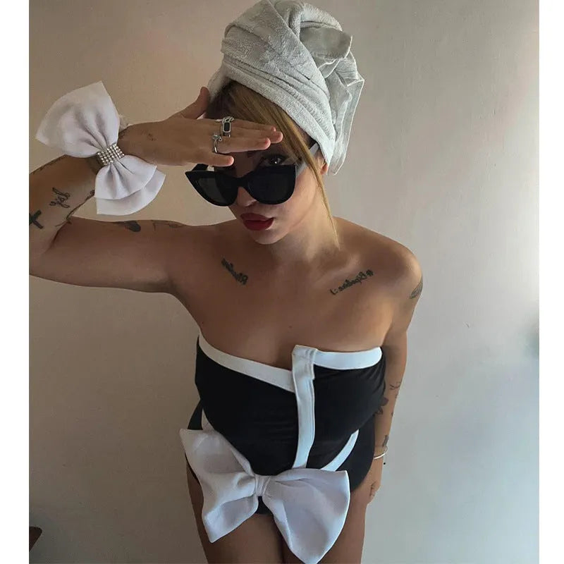 Black and white colour-block women's swimsuit with asymmetric tube top and bow detail