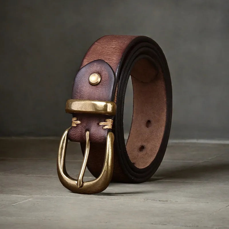 Men's casual leather belt in black with a copper pin buckle on a jeans background