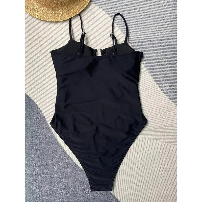 Black solid colour one-piece swimsuit for women on a mannequin, showing a tight fit.