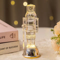 Clear plastic walnut soldier nutcracker Christmas ornament on a desktop