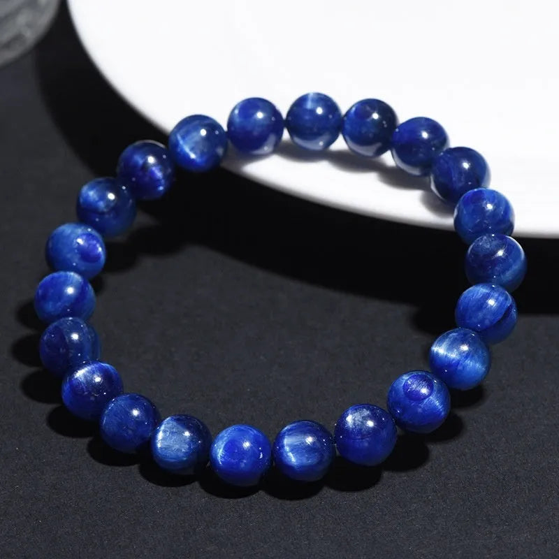 Natural blue crystal ball bracelet with geometric Ruyi design on a wrist.