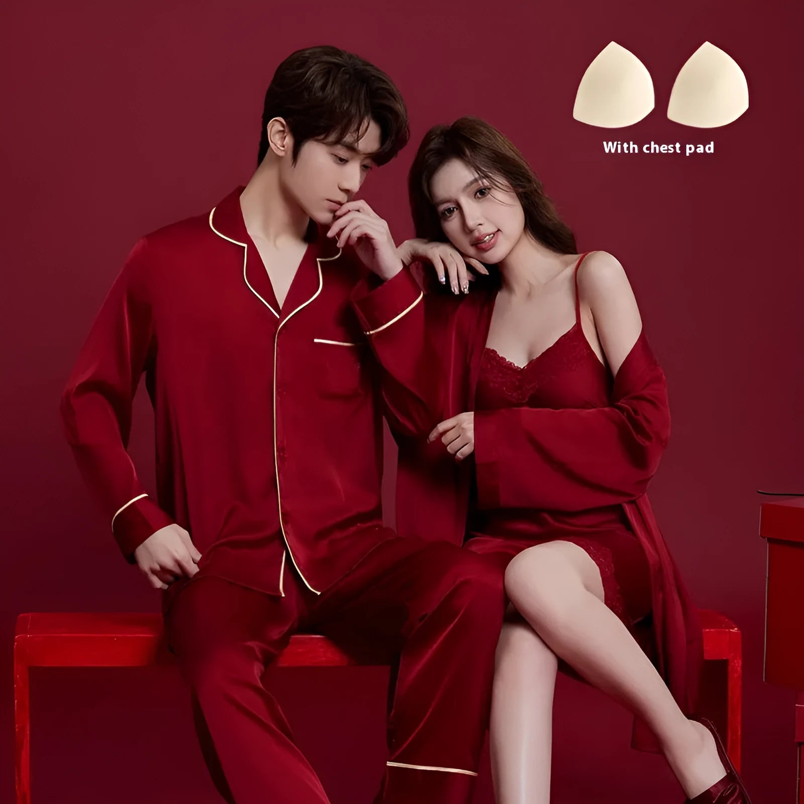 Red matching men's and women's ice silk sleepwear set with long sleeves and trousers.