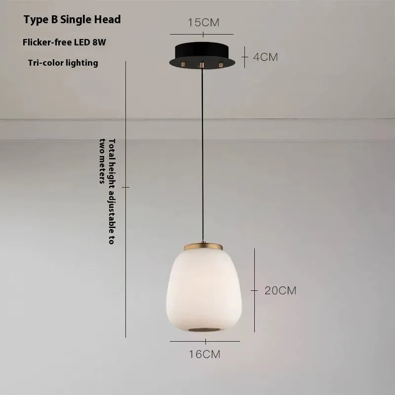 Modern minimalist long chandelier with iron frame and glass elements emitting warm LED light in a living room