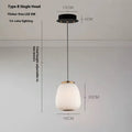 Modern minimalist long chandelier with iron frame and glass elements emitting warm LED light in a living room