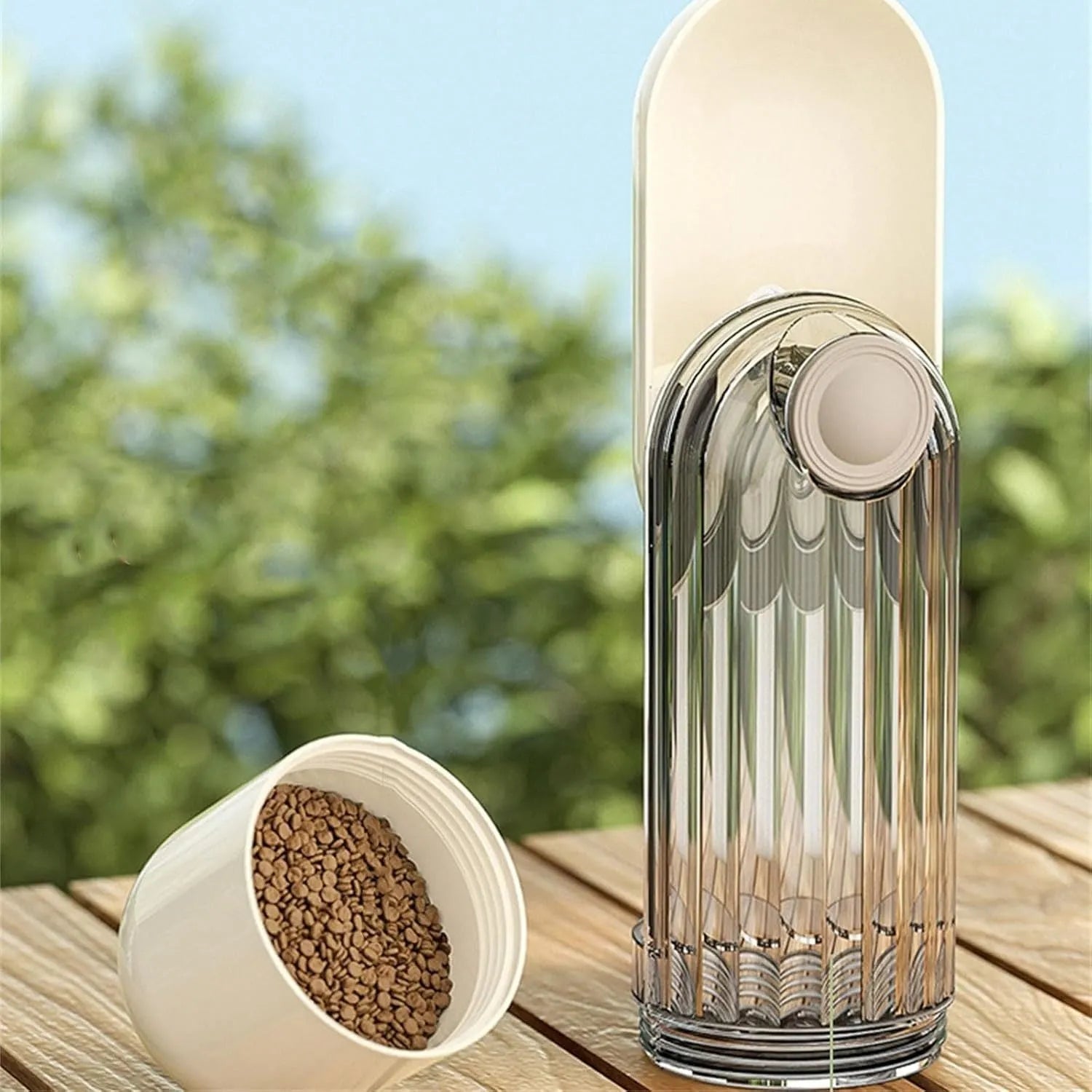 Beige foldable dog water bottle with food dispenser base for outdoor walking and travel
