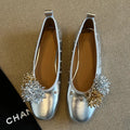 Women's silver Mary Jane flat shoes with a buckle strap and sheepskin upper.