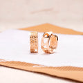 Rose gold tone women's earrings with a hollowed-out heart shape divided into three sections.
