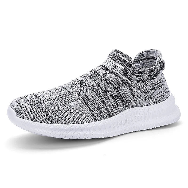 Men's lightweight Flyknit trainers in blue, shown from the side on a wooden deck.
