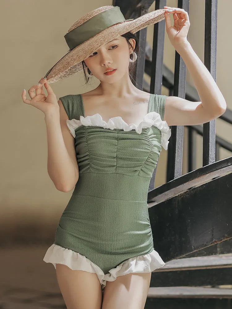 Black high-waisted one-piece swimsuit on a mannequin, showing quick-dry fabric and slimming cut.