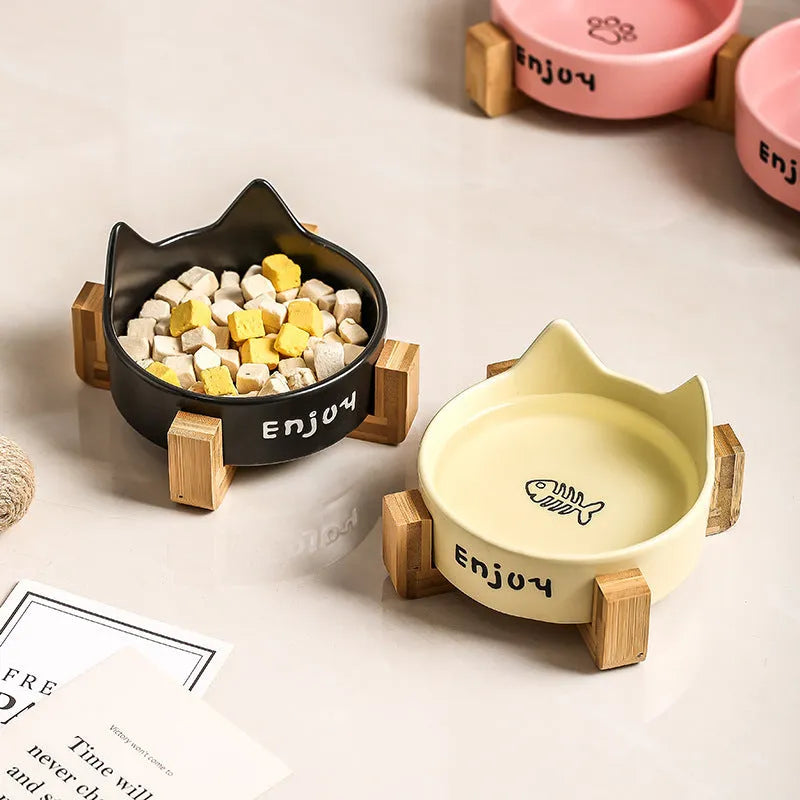 Porcelain cat bowl with wooden frame featuring cat paw pattern in pink colour