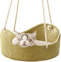 Green rattan cat hammock with cotton ropes and metal hooks, shown hanging