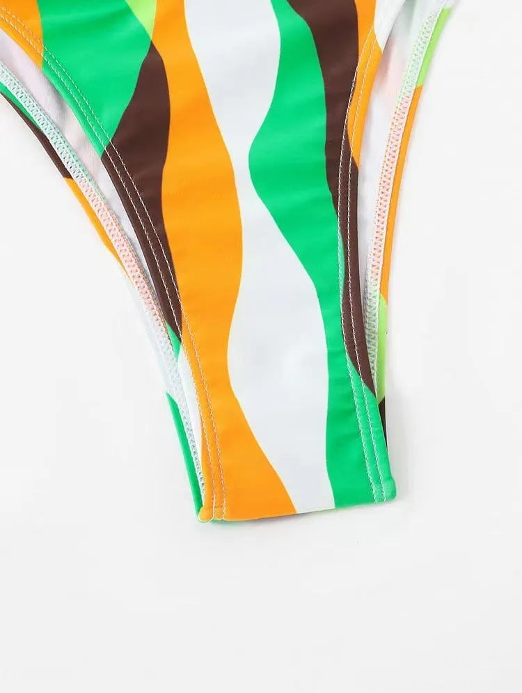 Women's yellow green printed three-piece bikini set with a matching skirt laid flat.