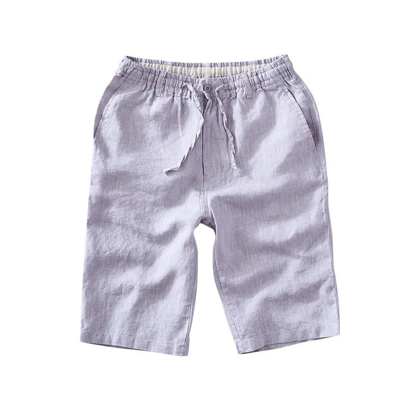 Men's loose-fitting linen capri pants in a light colour, showing the straight-leg style.