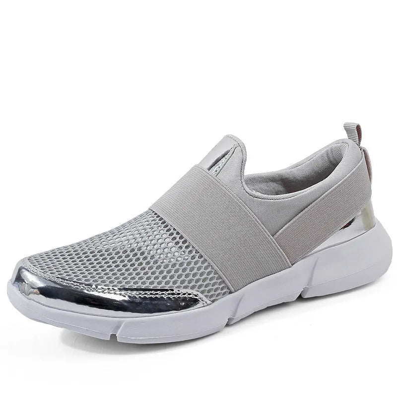 Low-cut blue, black, and grey women's sneakers with a mesh interior on a plain background.