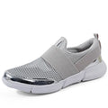 Low-cut blue, black, and grey women's sneakers with a mesh interior on a plain background.