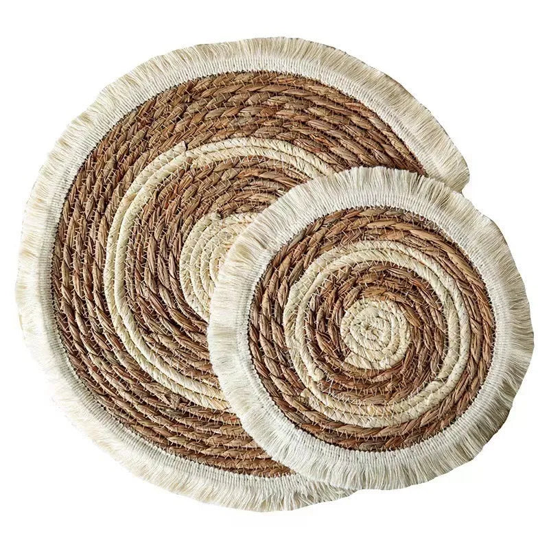 Round Japanese straw placemat with tassel edge in natural papyrus material on wooden dining table