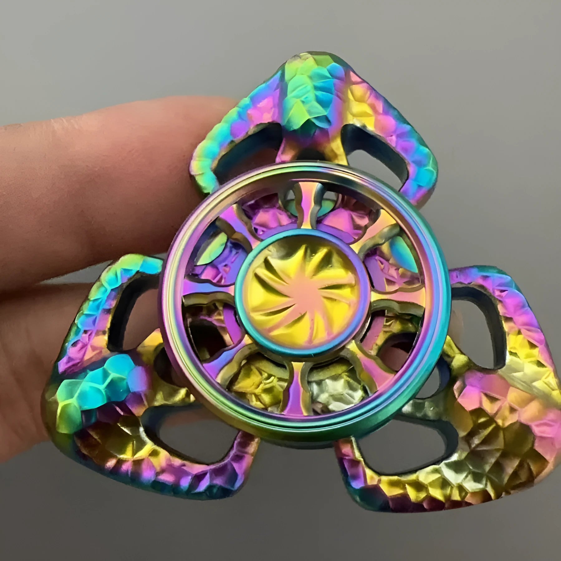 Flame Butterfly metal alloy rotating gyro spinner fidget toy on a flat surface.