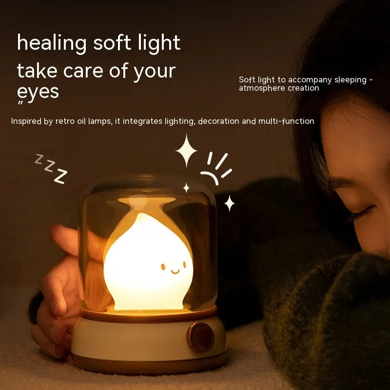 Green retro oil lamp design USB rechargeable LED desk night light on a wooden table.