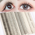 False eyelash glue kit with single-cluster lashes, pink and black adhesive, tweezers and brush tools