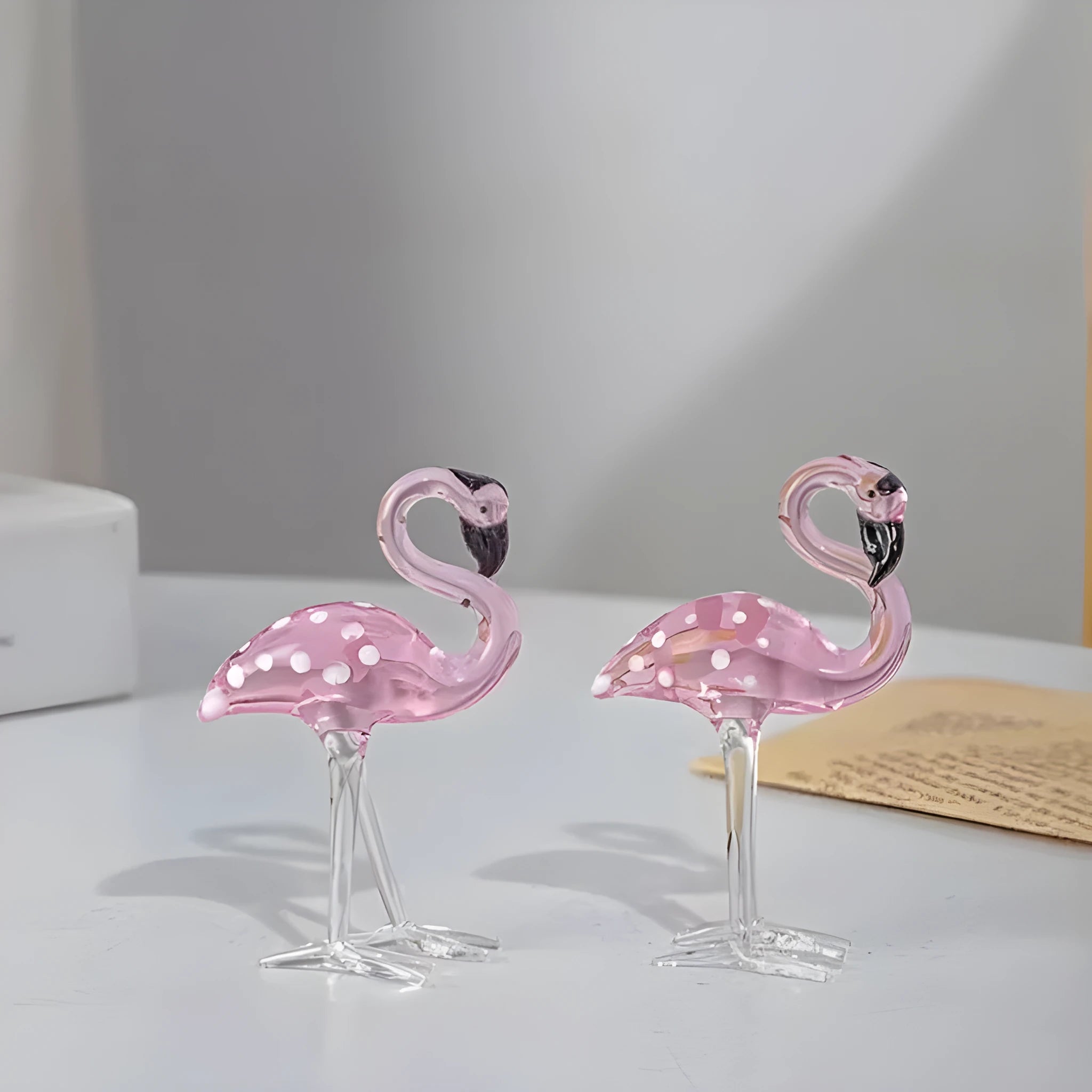 Pink crystal simulation flamingo decorative ornament on a table for home decor or gifting.