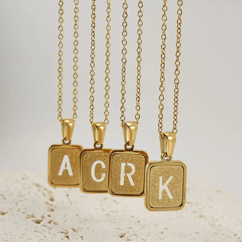 Alphabet necklace with square hollow-out letter pendant in titanium steel, gold or silver electroplated small snake chain