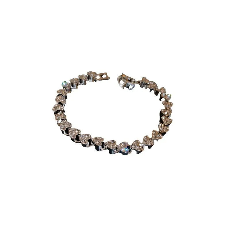 Silver heart shaped metal bracelet with inlaid zircon stones for women