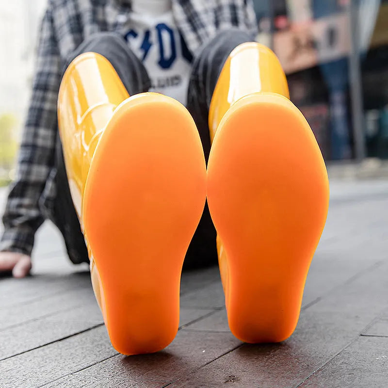 Men's flat washable plastic rain boot in white, showing high tube design and round toe.