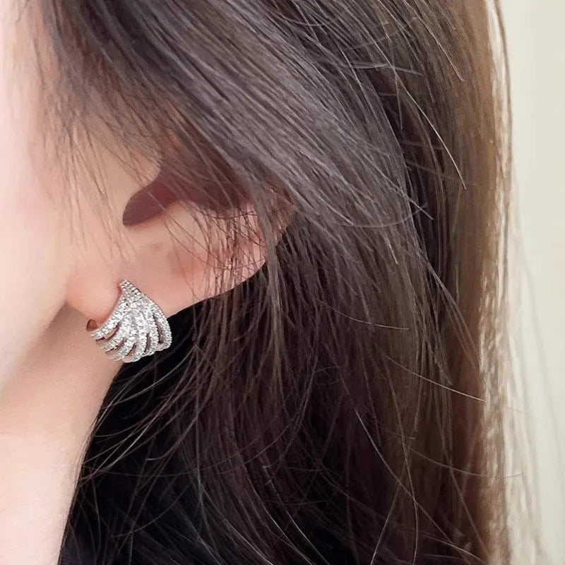 A pair of women's geometric design zircon earrings with a platinum colour electroplated finish.