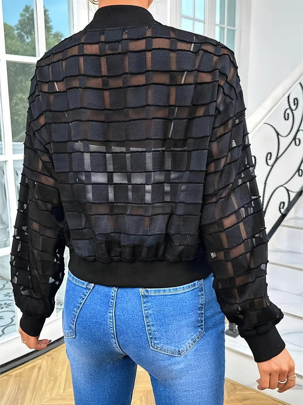Black women's casual jacket with geometric pattern and semi-transparent thread zipper detail.