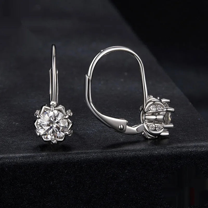 Sterling silver flower bud clip earring with moissanite stone and electroplated platinum finish.