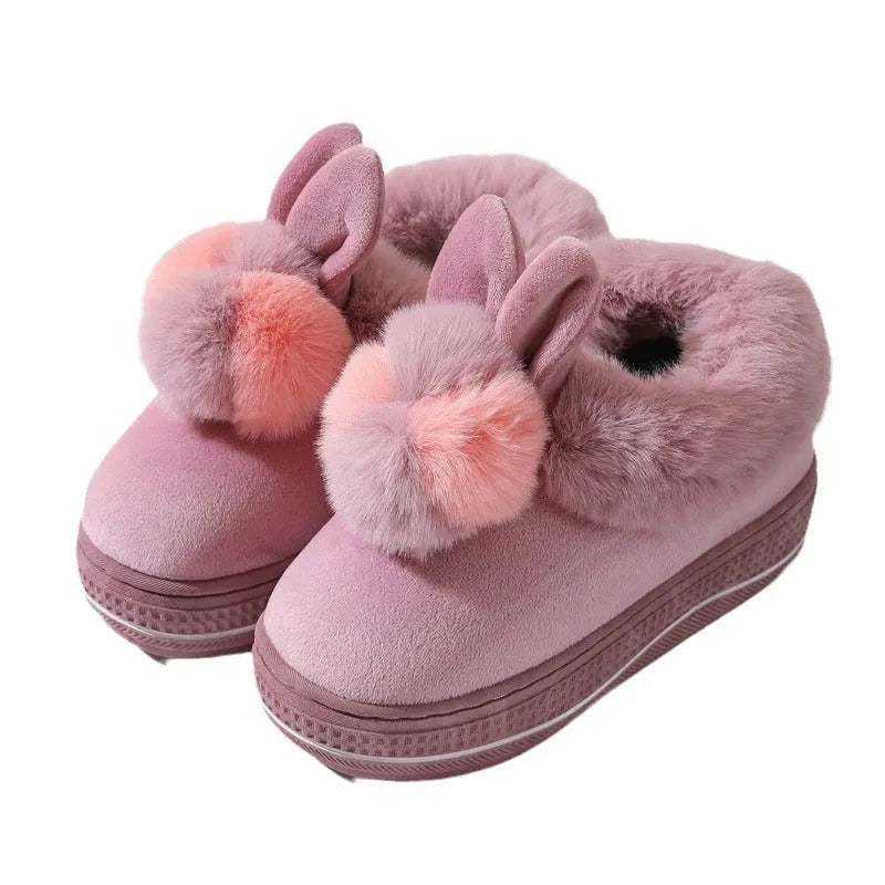 A pair of thick-soled high heel slippers in plush material with a TPR sole, shown in grey colour.