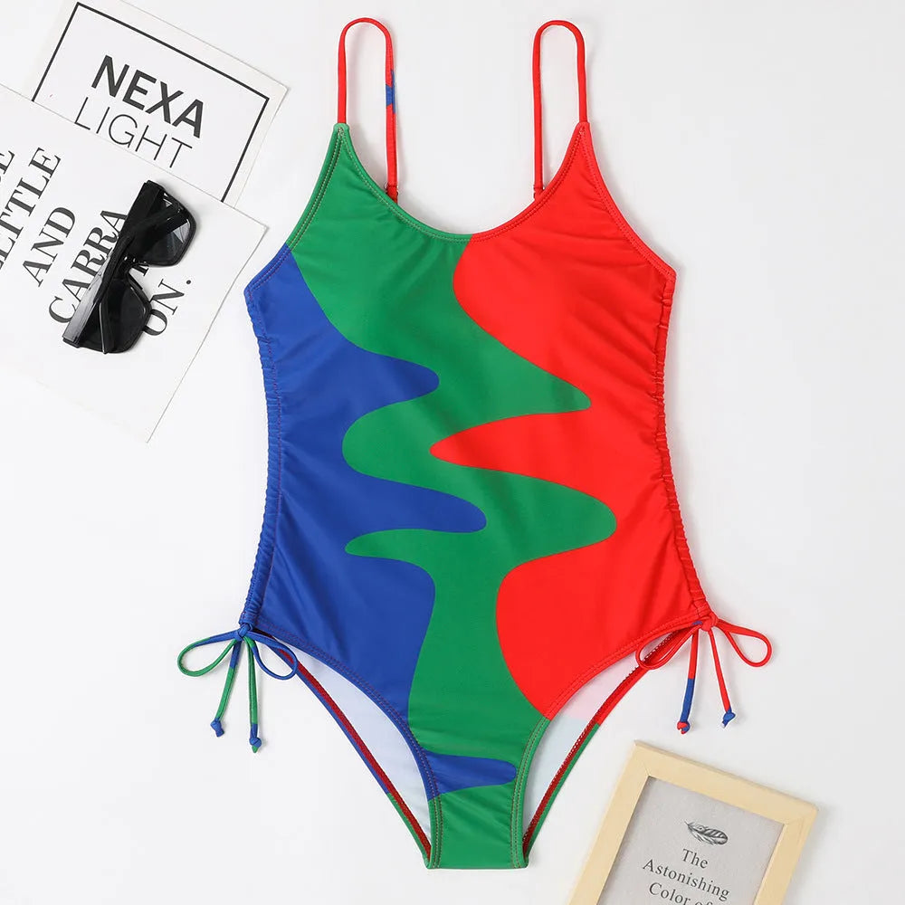 Women's blue one-piece swimsuit with sleeveless backless design and printed stripe pattern