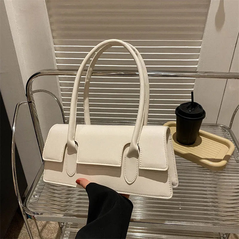 Women's horizontal square PU shoulder bag with stitching detail and single strap in black colour