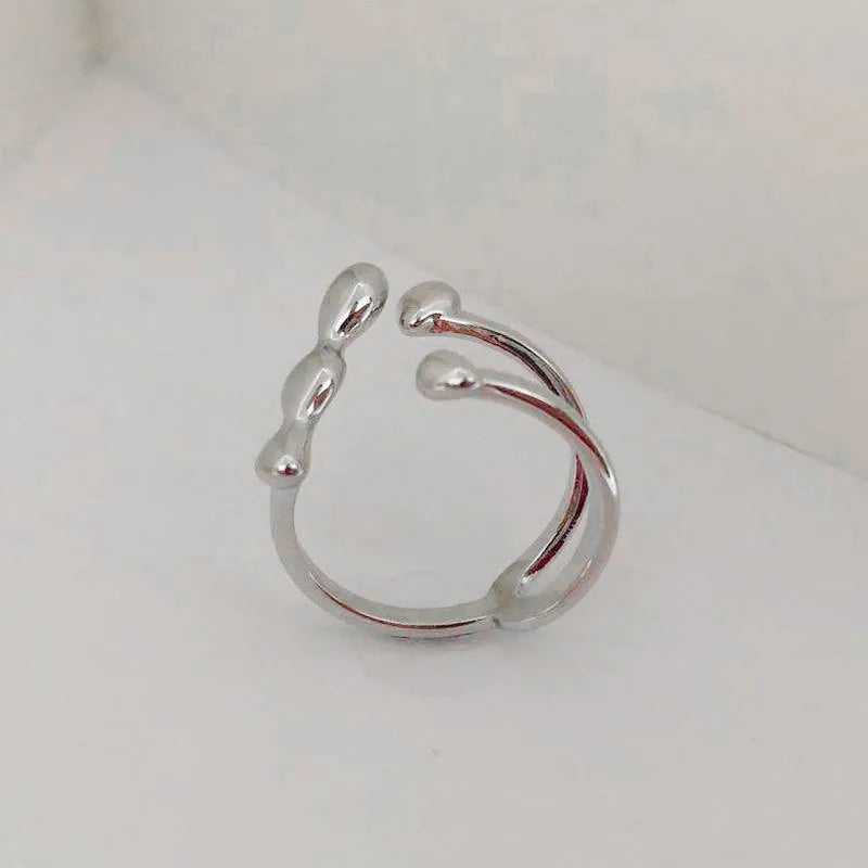 Brass opening ring with spherical design in gold or silver colour options